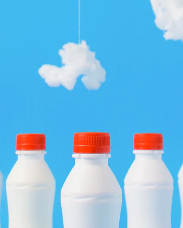 bouteilles de lait sur fond bleu avec des nuages, esthétique